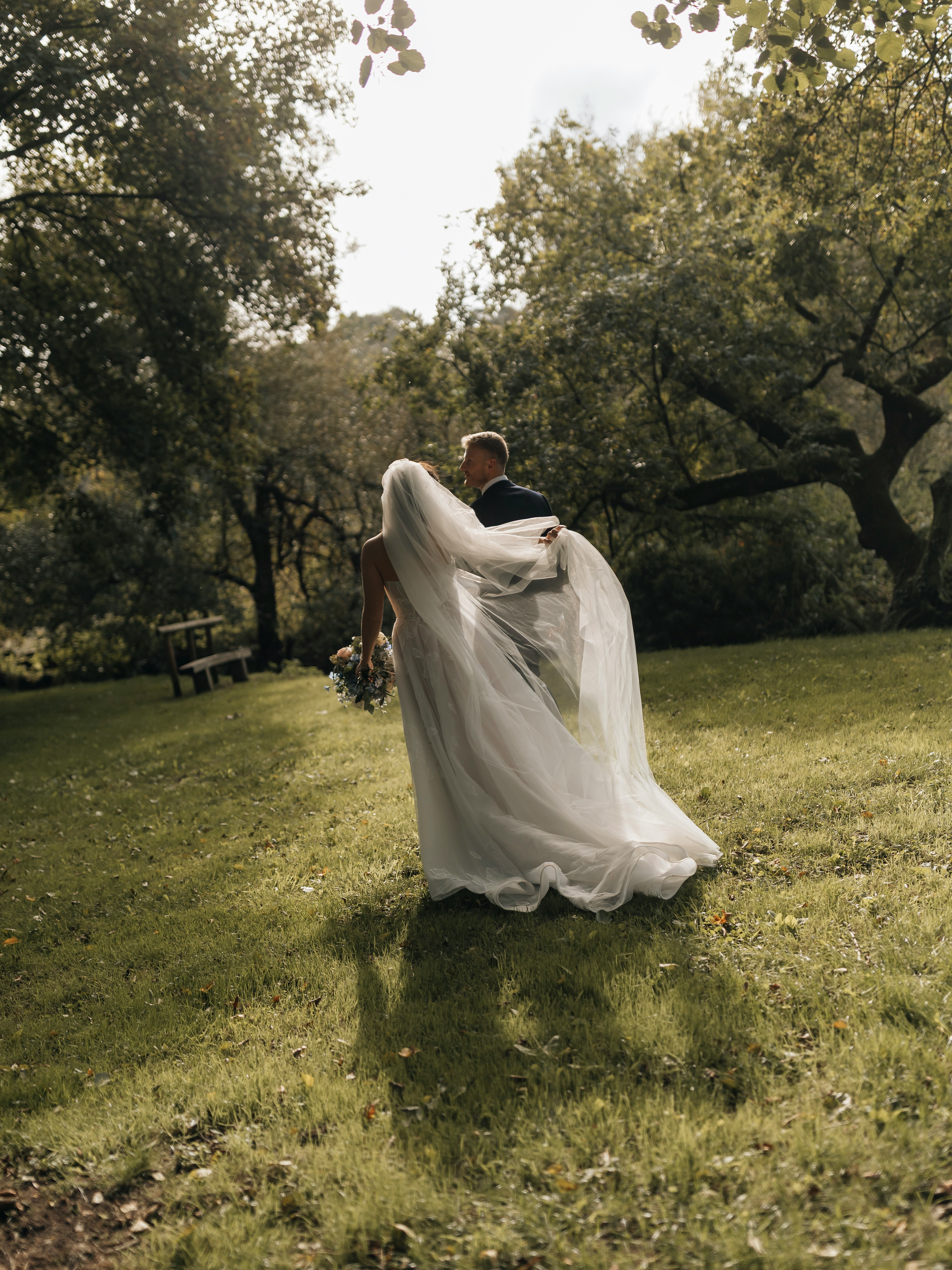 Priya and Daniel laughing during their first dance as confetti falls