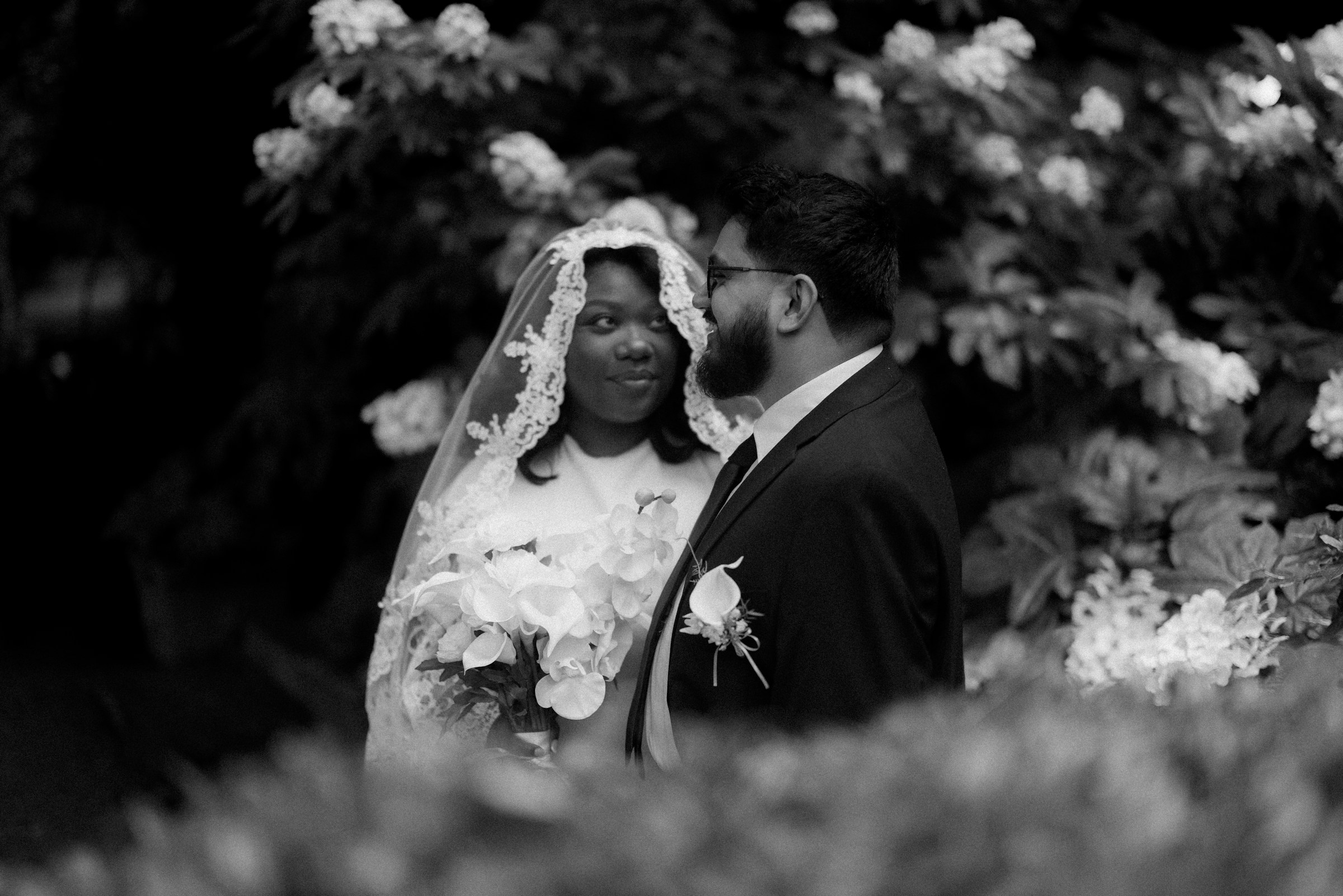 A couple together among flowers on the wedding day