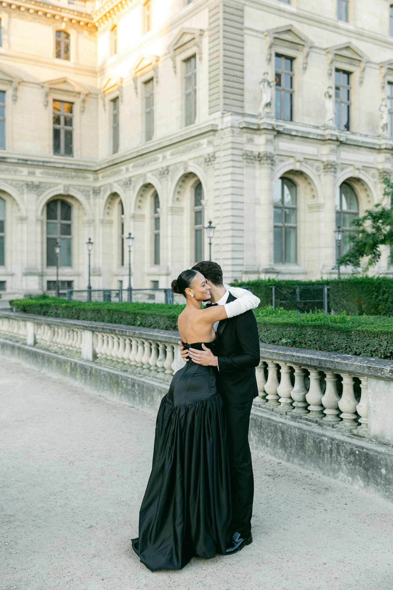 Couple embracing outside a grand stone building