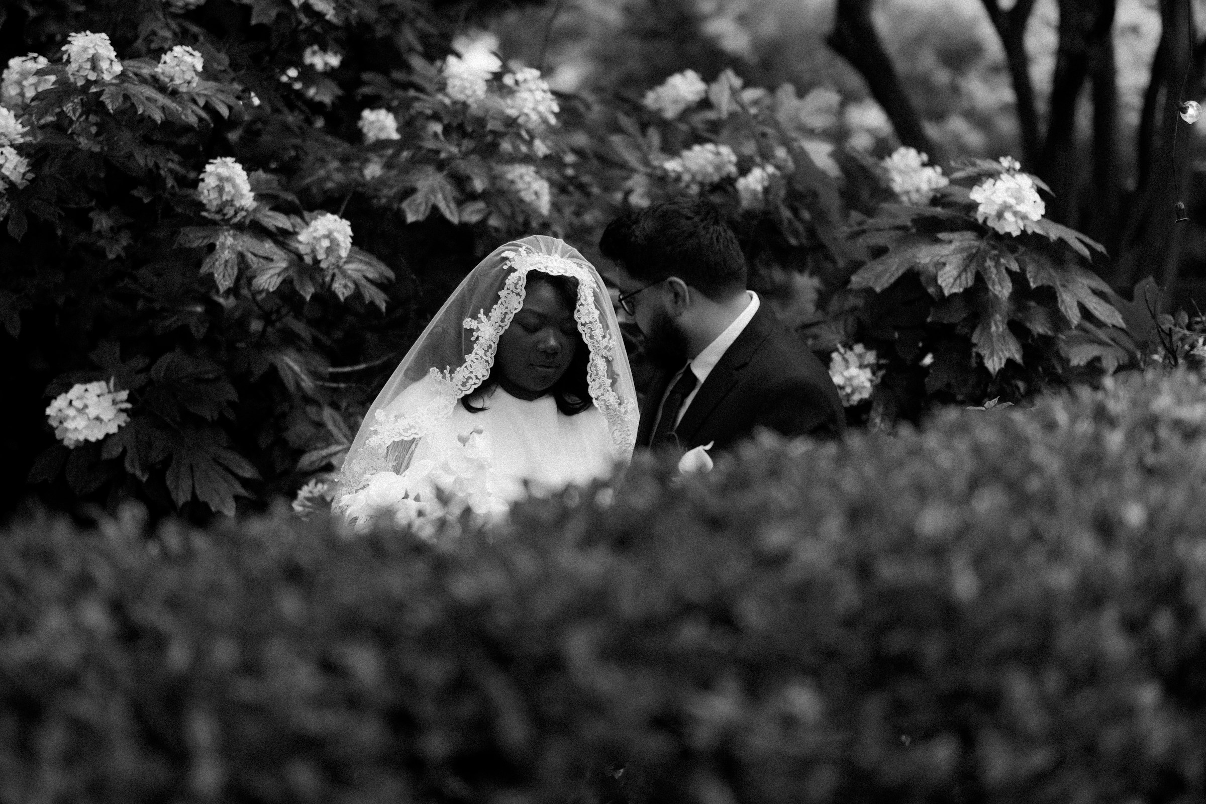A couple in a garden on their wedding day